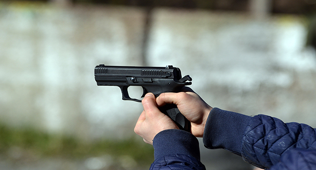 Person holding a hand gun. 